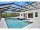 A screened-in swimming pool and hot tub, blending outdoor living with privacy and protection from the elements at 10139 Austrina Oak Loop, Winter Garden, FL 34787