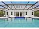 Back of the house featuring a beautiful pool area with a screened-in lanai and comfortable seating at 10139 Austrina Oak Loop, Winter Garden, FL 34787