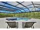 Attractive swimming pool and hot tub with screened-in enclosure, offering a tranquil and private outdoor space at 10139 Austrina Oak Loop, Winter Garden, FL 34787