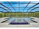 Beautiful screened-in pool and hot tub, featuring ample patio space for lounging and entertaining at 10139 Austrina Oak Loop, Winter Garden, FL 34787