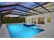 Swimming pool and hot tub with a screened enclosure, creating a luxurious and private outdoor oasis at 10139 Austrina Oak Loop, Winter Garden, FL 34787