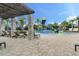 Community pool with lounge chairs, splash pad, and covered pergola area for relaxation at 10139 Austrina Oak Loop, Winter Garden, FL 34787