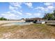 Wide view of large backyard with fenced pool and screened in patio of home's rear exterior at 1037 Abagail Dr, Deltona, FL 32725