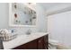 A well-lit bathroom featuring a marble countertop, sleek vanity, and a shower with a modern shower curtain at 1037 Abagail Dr, Deltona, FL 32725