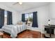 Well-lit bedroom with wood floors, a double window, and comfortable furnishings at 1037 Abagail Dr, Deltona, FL 32725