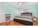 This spacious bedroom features a ceiling fan, wood floors, and a window letting in lots of natural light at 1037 Abagail Dr, Deltona, FL 32725