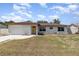 Charming single-story home with a light-colored exterior, yellow door, and attached one car garage at 1037 Abagail Dr, Deltona, FL 32725