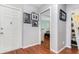Hallway with wood-look flooring, neutral paint, and access to a room in the background at 1037 Abagail Dr, Deltona, FL 32725