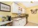 Bright kitchen with white cabinets, granite countertops, and a stainless steel sink under a window at 1037 Abagail Dr, Deltona, FL 32725