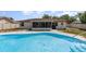 Rear exterior view of home and pool with screened in patio area for outdoor enjoyment at 1037 Abagail Dr, Deltona, FL 32725
