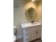 Bright bathroom featuring granite countertop, white vanity and an ornate mirror at 112 Crown Oaks Way # 112, Longwood, FL 32779