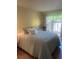 Comfortable bedroom featuring a well-made bed, with sliding door to the outdoor area, and neutral decor at 112 Crown Oaks Way # 112, Longwood, FL 32779