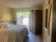 This comfortable bedroom includes a well-made bed, with view to the outside area, and an armoire at 112 Crown Oaks Way # 112, Longwood, FL 32779