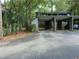 Exterior shot of the carport for the house, with a car parked underneath at 112 Crown Oaks Way # 112, Longwood, FL 32779