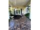 Clubhouse entrance featuring a patterned tile walkway, double doors, shutters, and manicured landscaping at 112 Crown Oaks Way # 112, Longwood, FL 32779