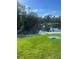 Scenic view of a community lake with lush greenery and mature trees reflecting on the water's surface at 112 Crown Oaks Way # 112, Longwood, FL 32779