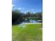Idyllic community lake features a floating dock, lush greenery, mature trees, and a serene waterfront at 112 Crown Oaks Way # 112, Longwood, FL 32779