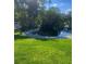 Peaceful lakeside gazebo featuring lush greenery, a winding concrete walkway, and scenic views of the community at 112 Crown Oaks Way # 112, Longwood, FL 32779