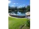 Serene community pool featuring stone accents and lush landscaping, creating an inviting resort-style amenity at 112 Crown Oaks Way # 112, Longwood, FL 32779
