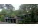 A row of condo units with individual carports surrounded by lush landscaping and mature trees at 112 Crown Oaks Way # 112, Longwood, FL 32779