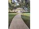 Inviting exterior view of the property with a walkway leading to the entrance at 112 Crown Oaks Way # 112, Longwood, FL 32779