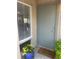 Inviting entryway features a gray front door, a welcome mat, and a planter with bright yellow flowers at 112 Crown Oaks Way # 112, Longwood, FL 32779