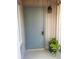 Stylish gray front door featuring a keypad lock and decorative plants, enhancing curb appeal at 112 Crown Oaks Way # 112, Longwood, FL 32779