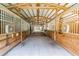 Spacious horse stable interior featuring multiple stalls, wooden construction, and a well-lit, open-air design at 112 Crown Oaks Way # 112, Longwood, FL 32779