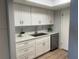 Bright kitchen featuring white cabinetry, stainless steel appliances, granite countertops and lots of storage at 112 Crown Oaks Way # 112, Longwood, FL 32779