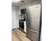 Updated kitchen featuring stainless steel appliances, modern flooring, and white cabinetry at 112 Crown Oaks Way # 112, Longwood, FL 32779