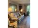 A stylish living room with a plush leather sofa, ample seating, and access to the patio at 112 Crown Oaks Way # 112, Longwood, FL 32779