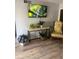 Cozy living room featuring a console table, a floral arm chair, and hard surface floors at 112 Crown Oaks Way # 112, Longwood, FL 32779