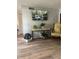 Cozy living room featuring a console table, a floral arm chair, and hard surface floors at 112 Crown Oaks Way # 112, Longwood, FL 32779