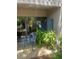 Cozy patio area featuring a glass table, chair, and sliding glass doors surrounded by lush greenery at 112 Crown Oaks Way # 112, Longwood, FL 32779