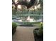 Picturesque pond featuring a stone border, lush landscaping, park bench and walkways at 112 Crown Oaks Way # 112, Longwood, FL 32779