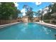 Inviting community pool with lounge chairs and umbrella, perfect for relaxation and recreation at 112 Crown Oaks Way # 112, Longwood, FL 32779