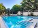 Sparkling blue community pool with steps, handrail, and ample seating area perfect for relaxation and recreation at 112 Crown Oaks Way # 112, Longwood, FL 32779