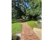 Landscaped park featuring a brick path winding through lush greenery and mature trees at 112 Crown Oaks Way # 112, Longwood, FL 32779
