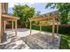 Large backyard patio with pavers and a covered pergola surrounded by a green hedge at 1130 Hardy Ave, Orlando, FL 32803