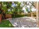 Spacious backyard with a paver patio, covered pergola, privacy fence and mature trees at 1130 Hardy Ave, Orlando, FL 32803