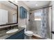 Bathroom featuring a shower with decorative tiles, a granite vanity, and storage at 1130 Hardy Ave, Orlando, FL 32803