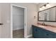 Bathroom features a vanity with granite countertop and a doorway to a walk-in closet at 1130 Hardy Ave, Orlando, FL 32803