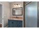 Bathroom featuring a granite countertop, framed mirror, and a glass-enclosed shower at 1130 Hardy Ave, Orlando, FL 32803