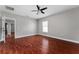 Bright bedroom with hardwood floors, a ceiling fan, and a window for natural light at 1130 Hardy Ave, Orlando, FL 32803