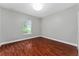 Bedroom featuring wood floors, ample natural light from a window and neutral walls at 1130 Hardy Ave, Orlando, FL 32803