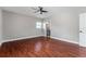 Bedroom with ceiling fan and hardwood floors, leading to an ensuite bathroom at 1130 Hardy Ave, Orlando, FL 32803