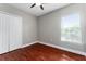 Bedroom with ceiling fan, wood flooring and a window for natural light at 1130 Hardy Ave, Orlando, FL 32803