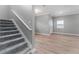 Inviting entryway featuring a staircase and light wood-look floors leading to the front door at 1130 Hardy Ave, Orlando, FL 32803