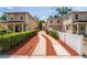 Charming two-story townhomes with tan stucco and a brick driveway entrance at 1130 Hardy Ave, Orlando, FL 32803
