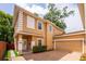 Beautiful exterior view of a two-story home with tan siding and attached garage at 1130 Hardy Ave, Orlando, FL 32803